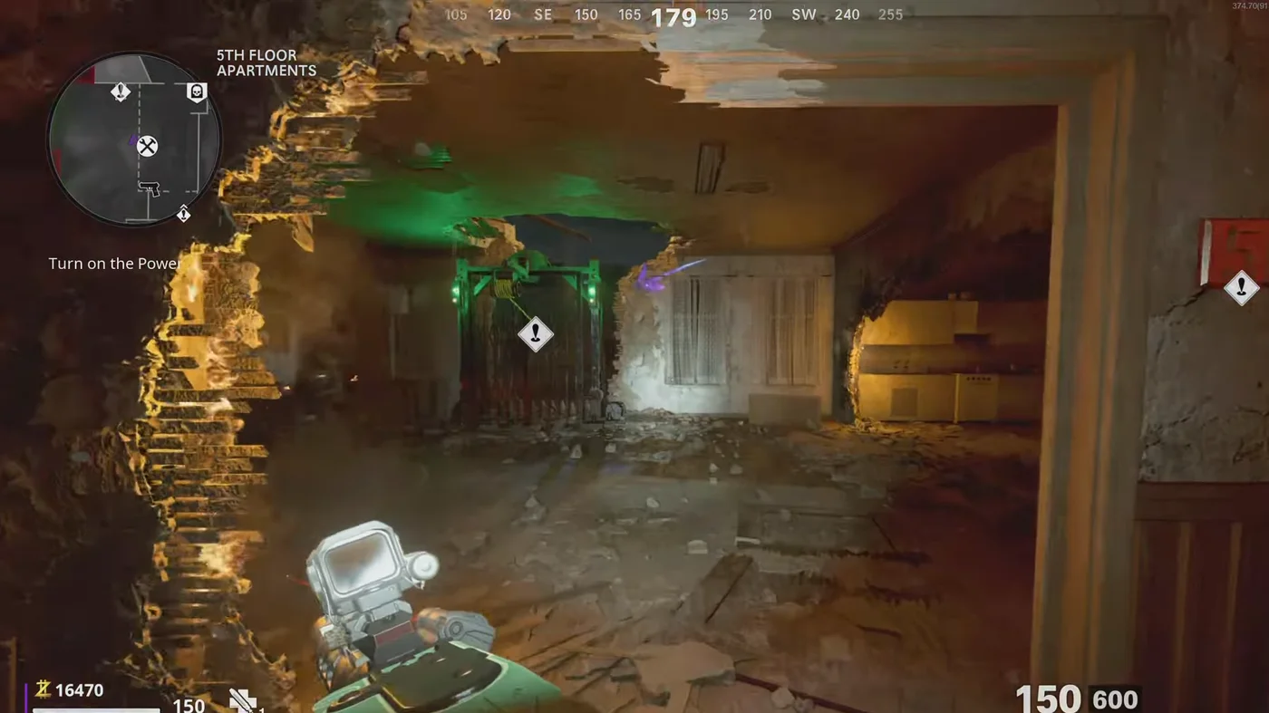 The hallway of the 5th Floor Apartments under the caved-in roof, with the green-lit gate of a zipline and a kitchen behind a broken wall, Mauer der Toten, Call of Duty Black Ops Cold War Zombies