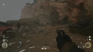 The starting beach, its sand covered in dead fish, with the red sea on the left and the cliffs and a cave mouth ahead, The Darkest Shore, Call of Duty WWII Zombies