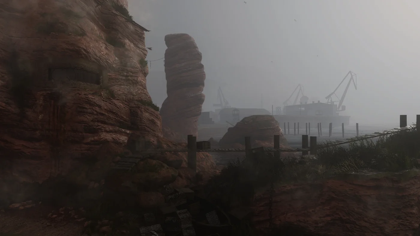 A tall sea stack rising from the fog beyond the cliffs, with the cranes of the harbour behind, official in-game view, The Darkest Shore, Call of Duty WWII Zombies