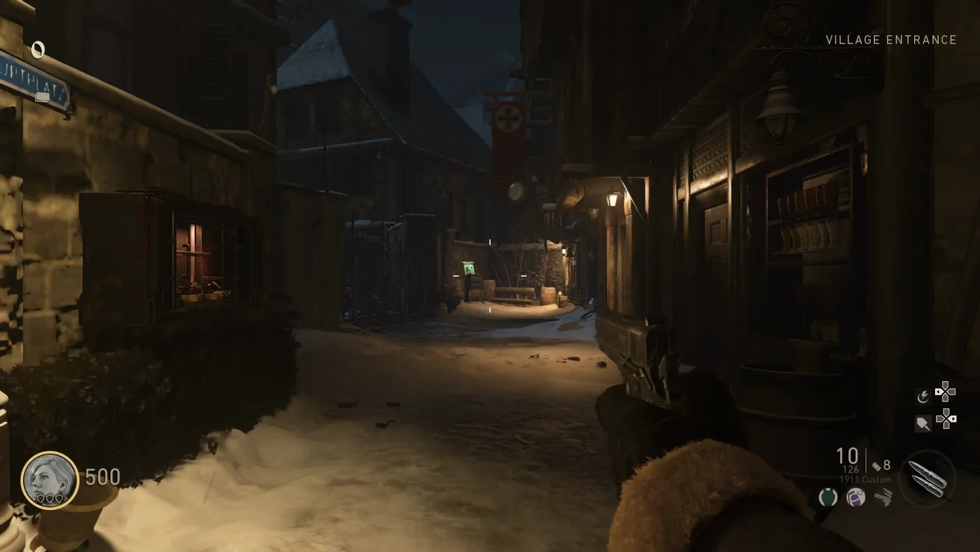 The narrow snowy alley of the Village Entrance at night, with Lebenblitz glowing green at the far end, The Final Reich, Call of Duty WWII Zombies