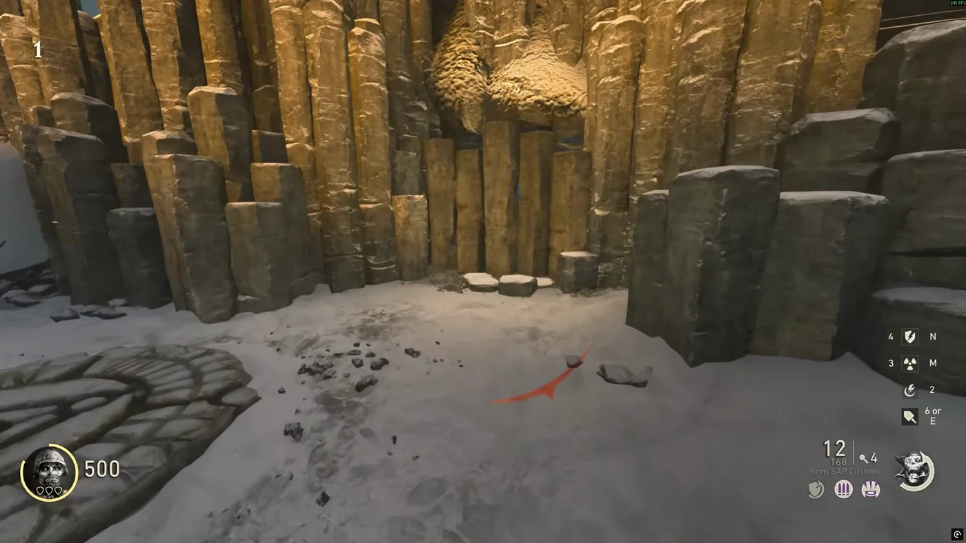 The wall of stone columns that hides the door to Thule, with the sacrifice stone in the snow in front of it, The Frozen Dawn, Call of Duty WWII Zombies